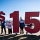 Activists with Our Revolution hold $15 minimum wage signs outside the Capitol complex on Thursday, Feb. 25, 2021, to call Congress to pass the $15 federal minimum wage hike proposed as part of the COVID relief bill.